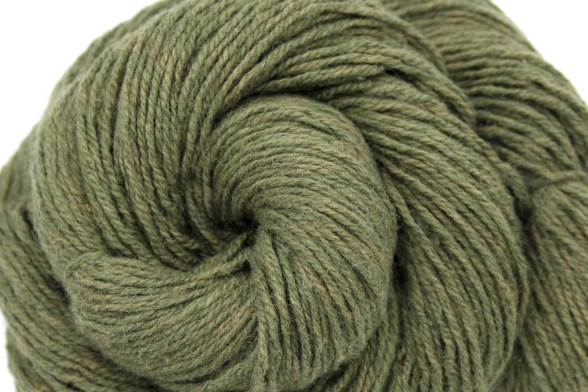 A close up shot of a skein of Heathered Sage, Olive Green, Cotton/ Nylon/ Wool, Sport weight Yarn recycled by hand from unwanted sweaters beautifully coiled in the center of the frame.