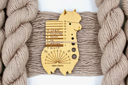 A skein of Tan, 40% Wool, 30% Nylon, 30% Modal, Worsted Weight Yarn recycled by hand from unwanted sweaters draped over the center of the frame with one strand on top of a Llama shaped Yarn weight tool, to better illustrate the thickness of the yarn. 