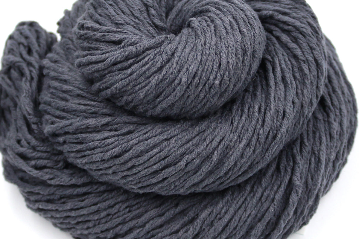 A close up shot of a skein of Vegan, Dark Grey, 60% Cotton, 40% Acrylic, Worsted Weight Yarn recycled by hand from unwanted sweaters beautifully coiled in the center of the frame. 