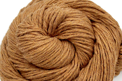 A close up shot of a skein of Vegan, Orangey Brown, 100% Cotton, Worsted Weight Yarn recycled by hand from unwanted sweaters beautifully coiled in the center of the frame. 