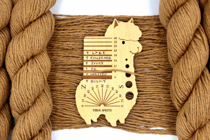 A skein of Vegan, Orangey Brown, 100% Cotton, Worsted Weight Yarn recycled by hand from unwanted sweaters draped over the center of the frame with one strand on top of a Llama shaped Yarn weight tool, to better illustrate the thickness of the yarn. 