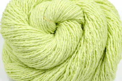 A close up shot of a skein of Vegan, Neon Greenish Yellow, Cotton, Acrylic, Polyester, Sport Weight Yarn recycled by hand from unwanted sweaters beautifully coiled in the center of the frame. 