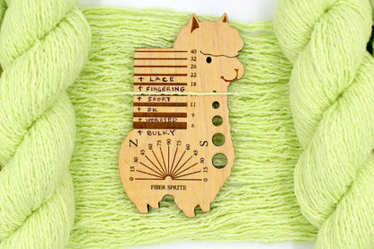 A skein of Vegan, Neon Greenish Yellow, Cotton, Acrylic, Polyester, Sport Weight Yarn recycled by hand from unwanted sweaters draped over the center of the frame with one strand on top of a Llama shaped Yarn weight tool, to better illustrate the thickness of the yarn. 