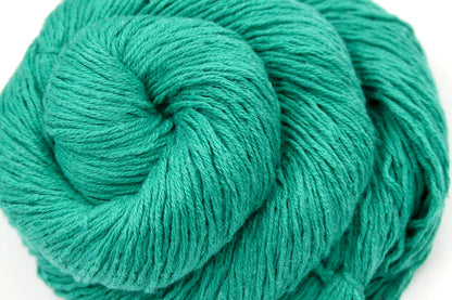 A close up shot of a skein of Vegan, Jungle Green, Cotton/ Acrylic, Fingering weight Yarn recycled by hand from unwanted sweaters beautifully coiled in the center of the frame. 