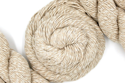A skein of Vegan, Light Tan/ Taupe/ Khaki, 100% Cotton, Sport weight Yarn recycled by hand from unwanted sweaters swirled attractively in the center of the frame. 