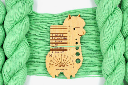 A skein of Vegan, vibrant light green, 100% Cotton, Worsted Weight Yarn recycled by hand from unwanted sweaters draped over the center of the frame with one strand on top of a Llama shaped Yarn weight tool, to better illustrate the thickness of the yarn. 