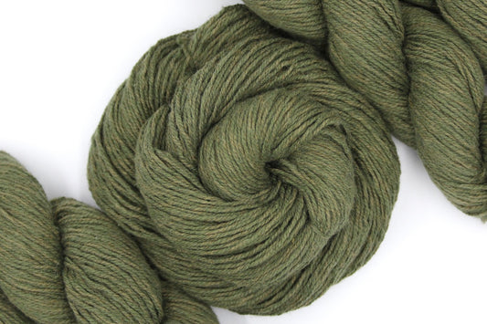 A skein of Heathered Sage, Olive Green, Cotton/ Nylon/ Wool, Sport weight Yarn recycled by hand from unwanted sweaters swirled attractively in the center of the frame. 