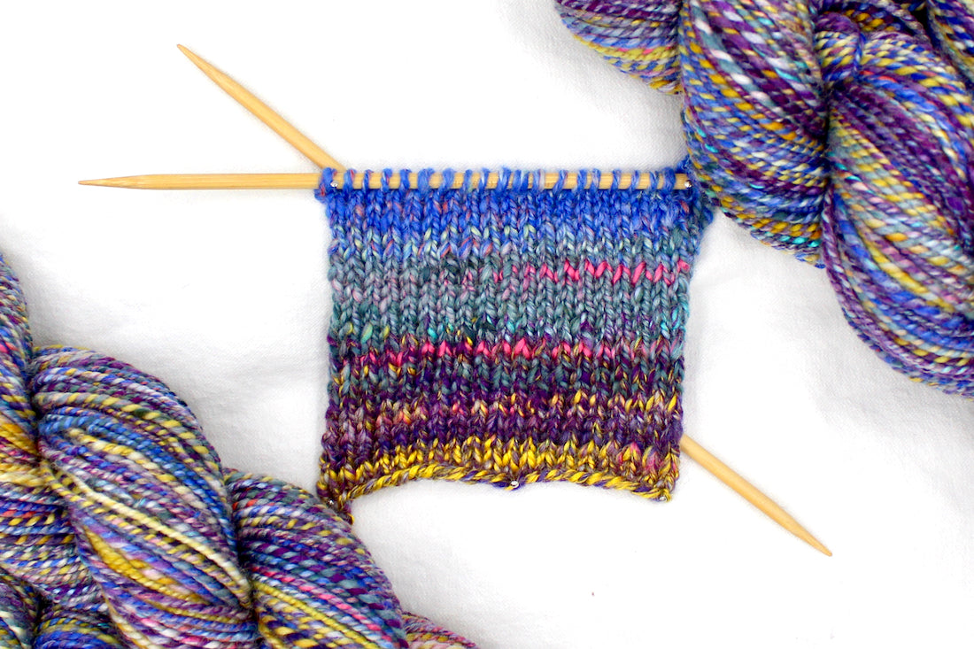 A sample swatch knitted on size 5 knitting needles from a one of a kind, Worsted Weight, hand dyed variegated skein of Rainbow multicolored self-striping Hand spun Yarn, made with Hand Dyed Wool and Bamboo. 